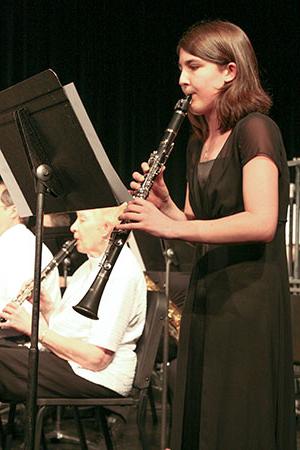 woman playing the clarinet at a concert